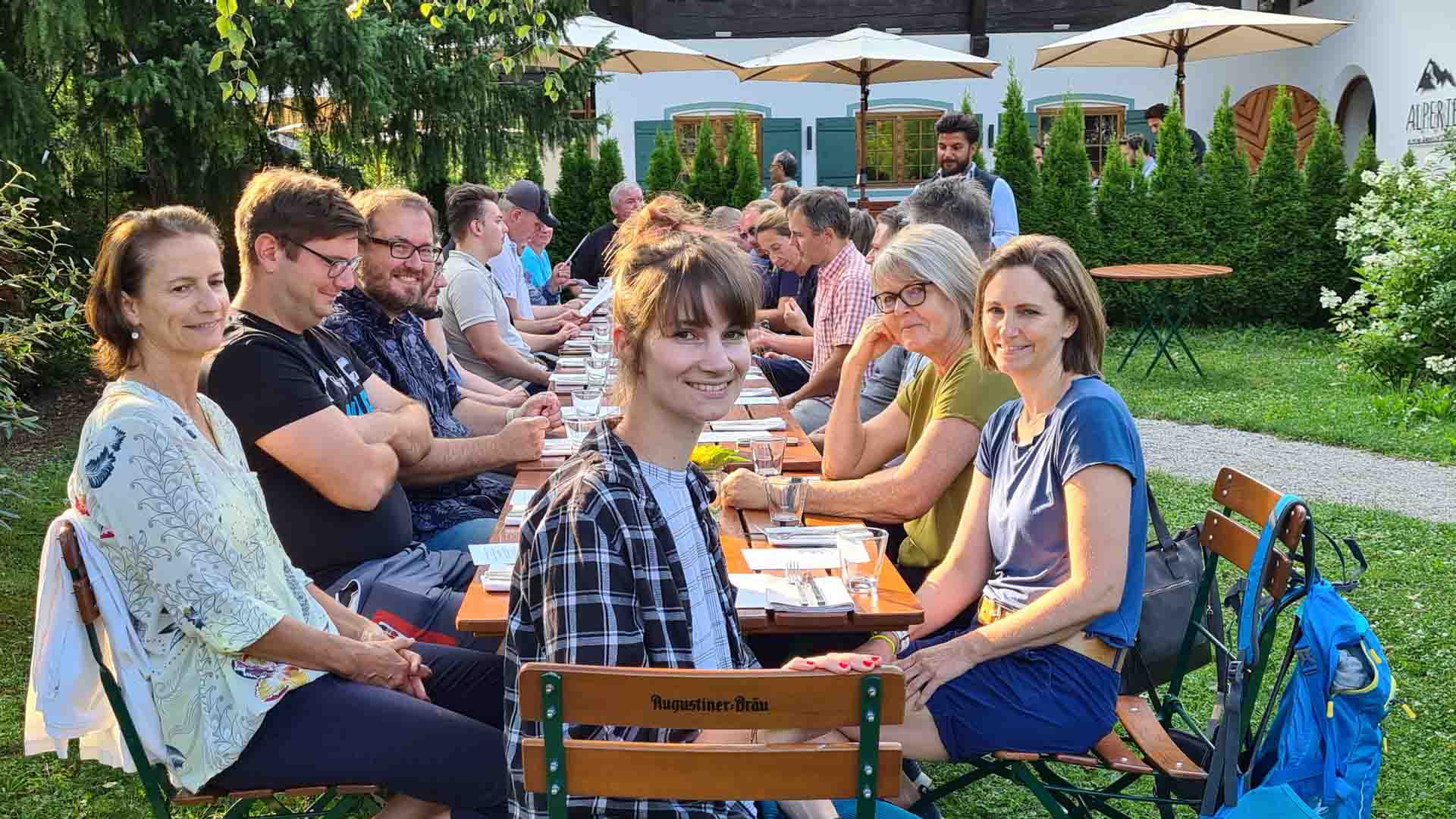 Mitarbeitende der Firma Steigauf sitzen beim Firmenevent im Gartenrestaurant.